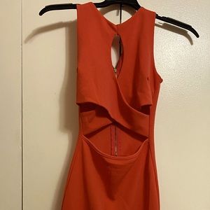 Orange fitted cut out dress.